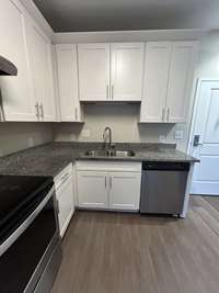Just inside the front door, the well-equipped kitchen in neutrals that will blend with any decor.