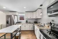 The kitchen offers a convenient double oven and a nearby pantry for ample storage and functionality.