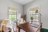 A serene front office overlooks the lush front yard. This is a work from home dream space.