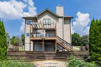 Outside, tiered entertaining spaces lead to a spacious flagstone fire pit.