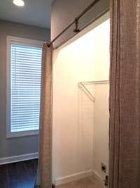 Washer and dryer hook- ups are conveniently located on the main floor of the home. A cozy half bath is tucked away just to the right of the laundry.