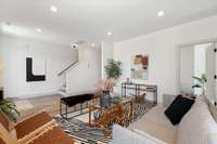 The ground level entry from the covered porch has a spacious living area (one of two) and a flex room.