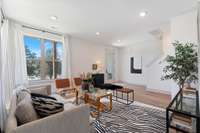 The ground level entry from the covered porch has a spacious living area (one of two) and a flex room.