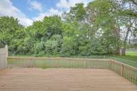 Partially fenced yard off back deck area