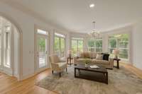 Family room area off the kitchen and connected to porch. Virtually staged
