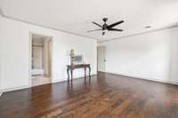 The primary bedroom boasts a private en-suite bath and a walk-in closet with a custom California Closet system...