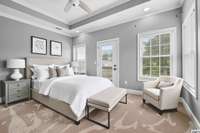 second large ensuite bedroom with additional trey ceiling detail, overhead lighting, extra windows, and back balcony.  **Virtually Staged**