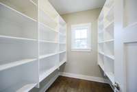 Stock up and hide all of your small appliances in this large walk in pantry.