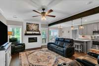 Cozy living room with electric fireplace wrapped in shiplap is ready for cozy fall nights