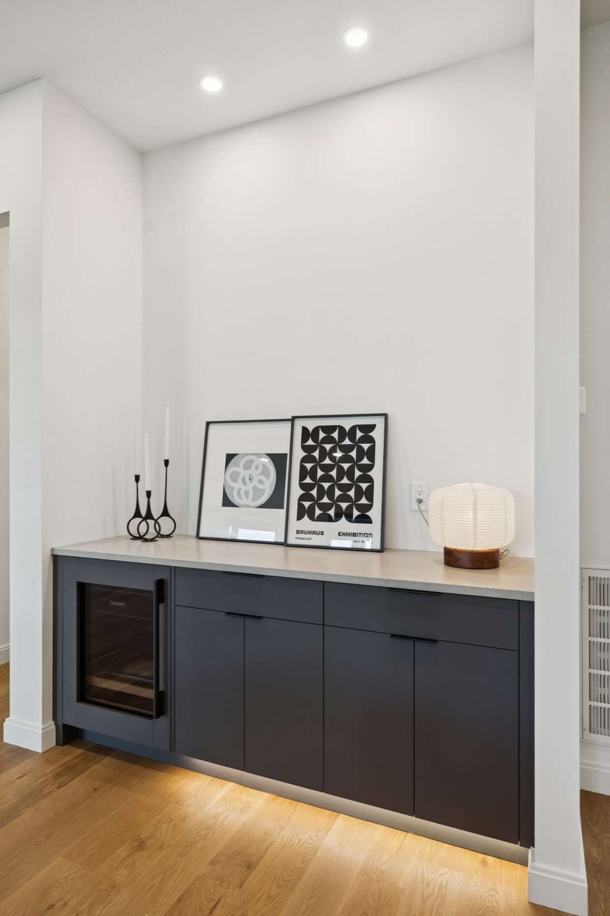 Serving bar with beverage refrigerator adjacent to the dining area