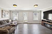 Rec space - perfect for a home office, home gym or media room. Artwork above the couch is virtually staged