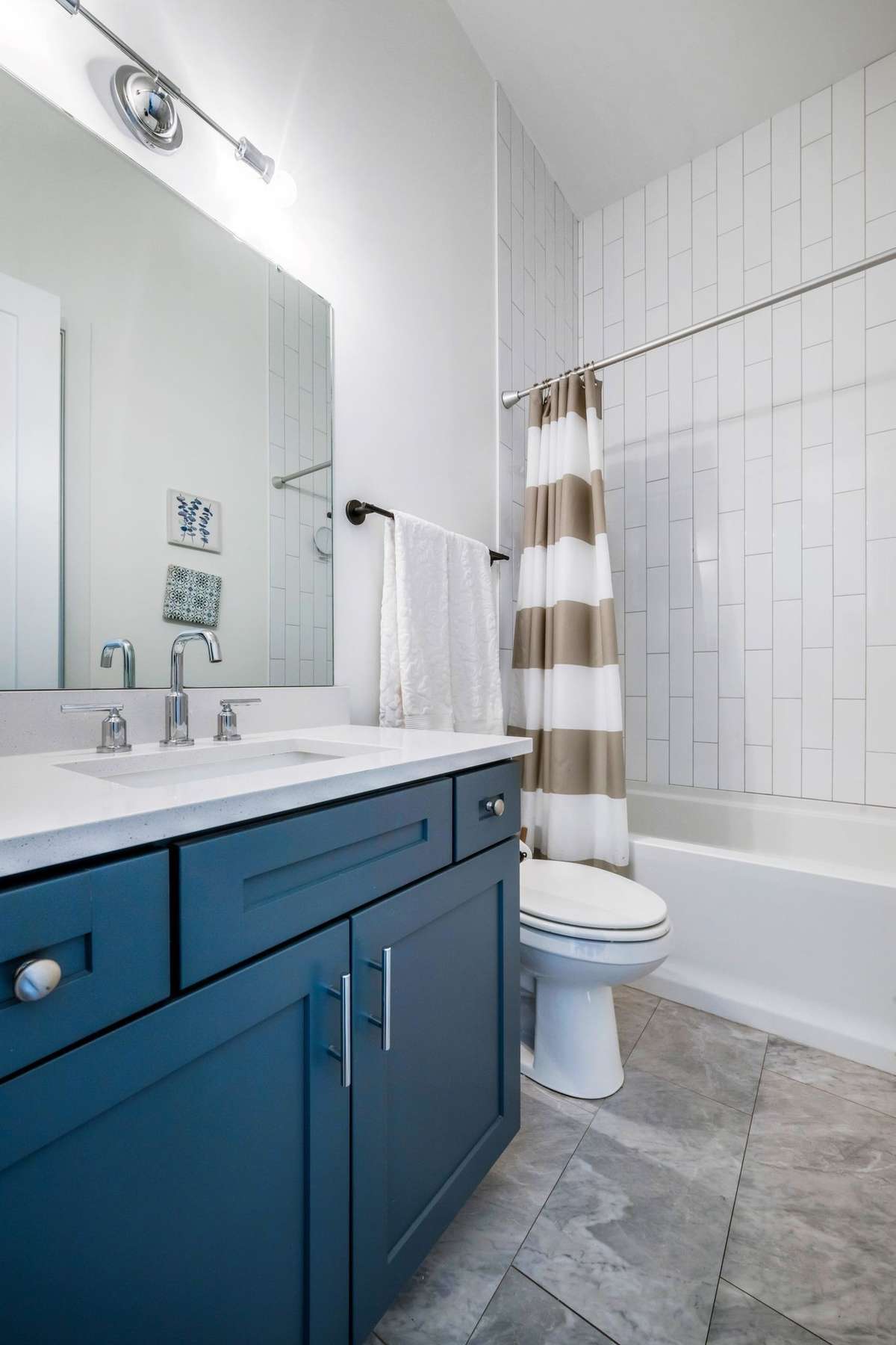 This first floor full bath has hallway and adjoining bedroom/office access.