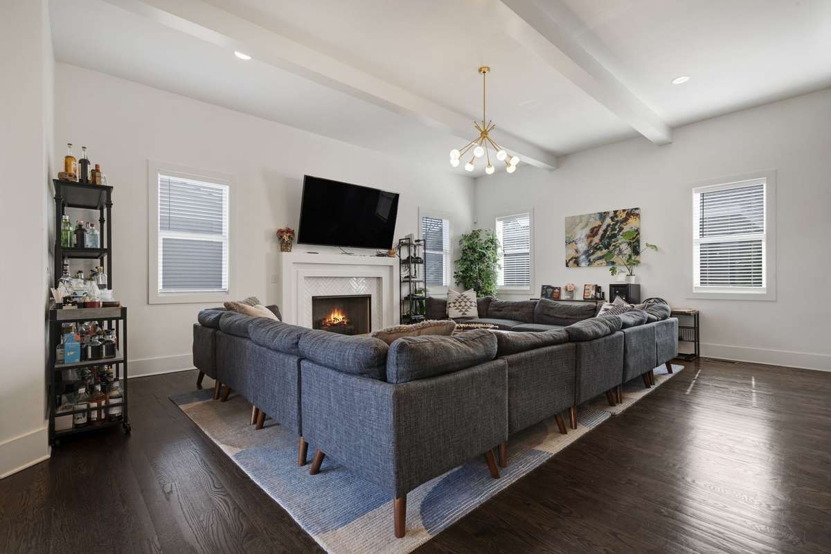 This living room can accommodate a massive sectional (avail for sale) anchord by the tiled gas fireplace and exposed ceiling beams for approachable drama.