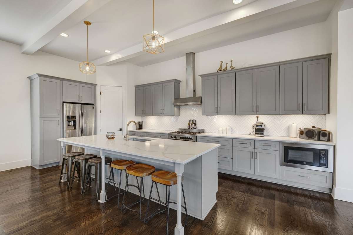 Bring your cooking skills and break bread on this oversized quartz island with room for 6 for  casual dining.