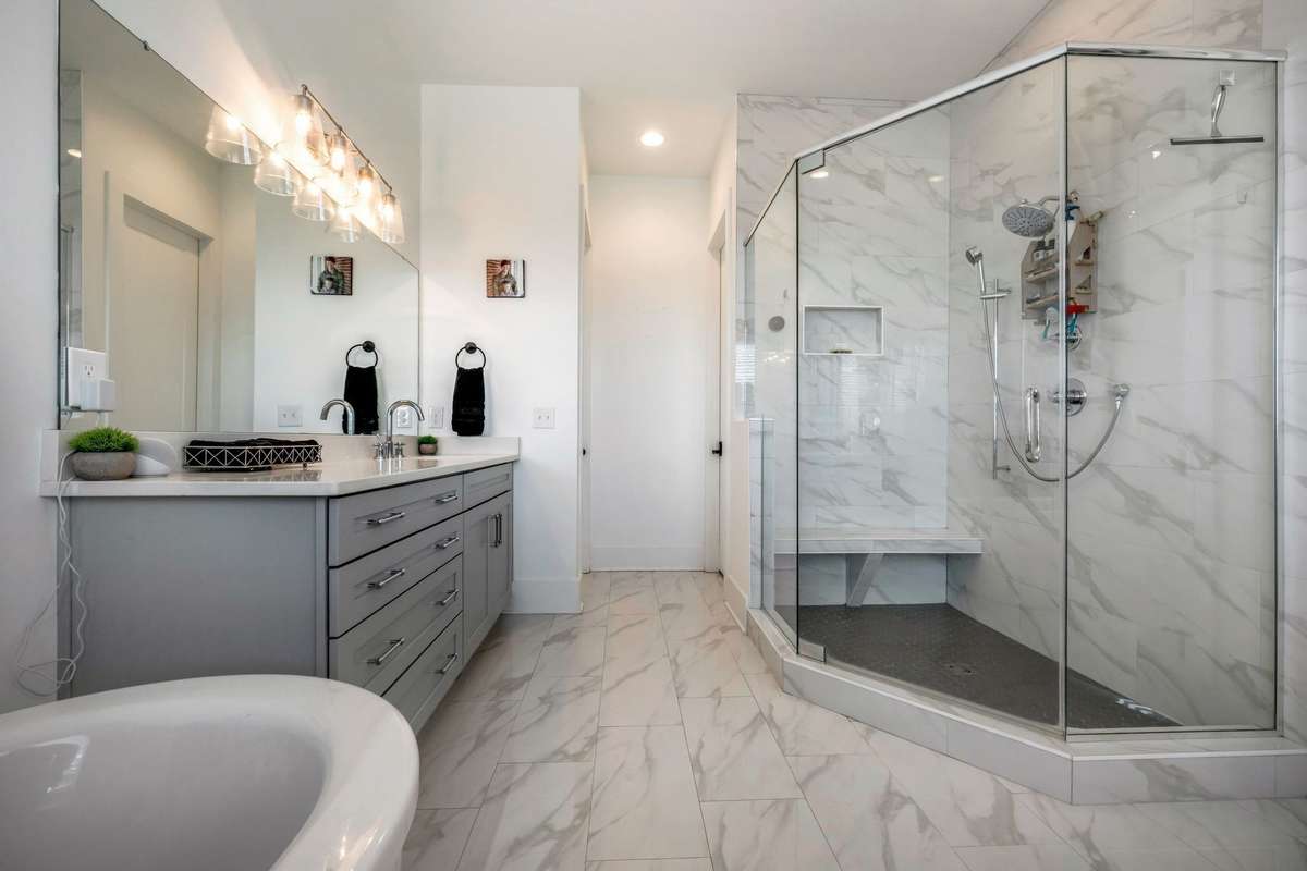 And you'll be ready to jump out of bed to indulge in this spa-like bath with oversized walk-in shower with seat bench, free standing soaking tub and 2 separate vanities.  Linen closet and private WC.