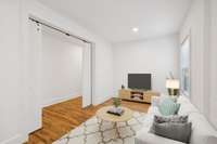 This flex space can be used as a den.  The barn doors allow for privacy. The room has been virtually staged.