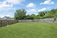 Your back yard is enveloped by a tall privacy fence, allowing you to create the perfect private outdoor oasis.  Additionally, a green screen of trees offers additional privacy.