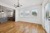 This photo features the living room that is open to the kitchen.