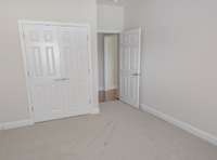 Front bedroom with closet. New carpets and fresh paint.