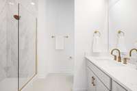 Frameless glass shower with mosaic tile flooring and floor to ceiling wall tiles