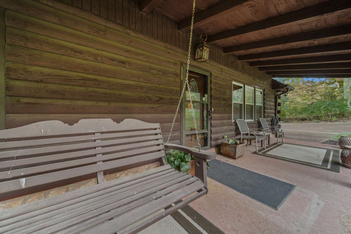 Spacious front porch perfect for morning sunrises or evening sunsets, with plenty of room for hanging plants and outdoor seating.