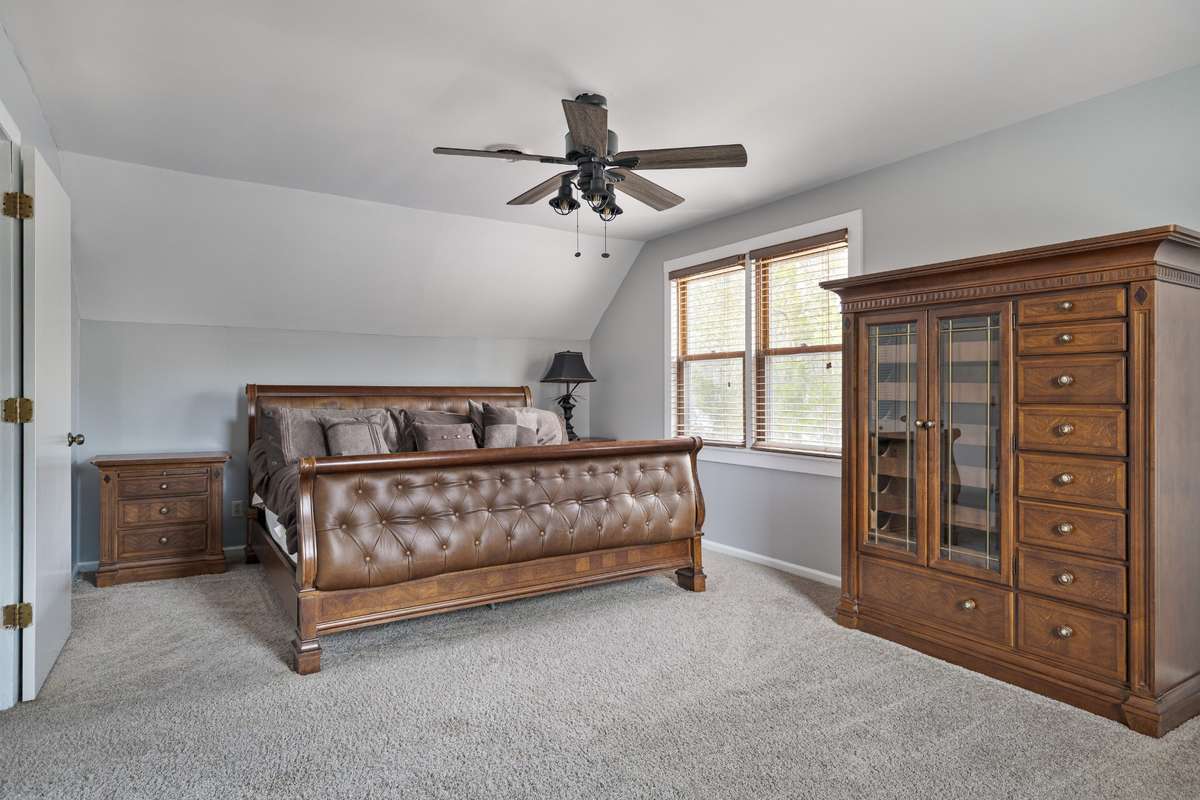 Second-floor bedroom, freshly painted, ideal as an additional primary with two generous closets.
