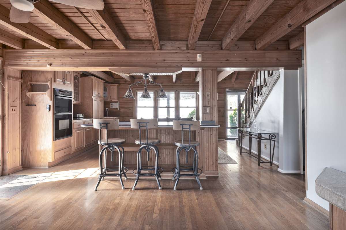 Open layout with neutral colors and a multi-use island—cook, serve, or dine.