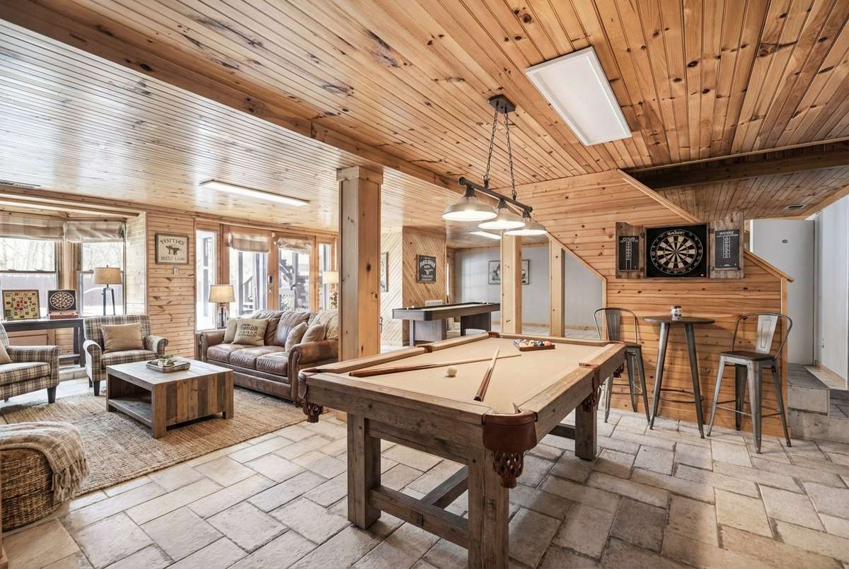 Digitally enhanced image of the finished basement highlights its versatility—relax, work, or play!
