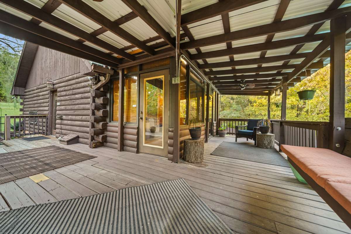Semi-wraparound deck offers dual access to the sunroom, perfect for entertaining and soaking in the views.