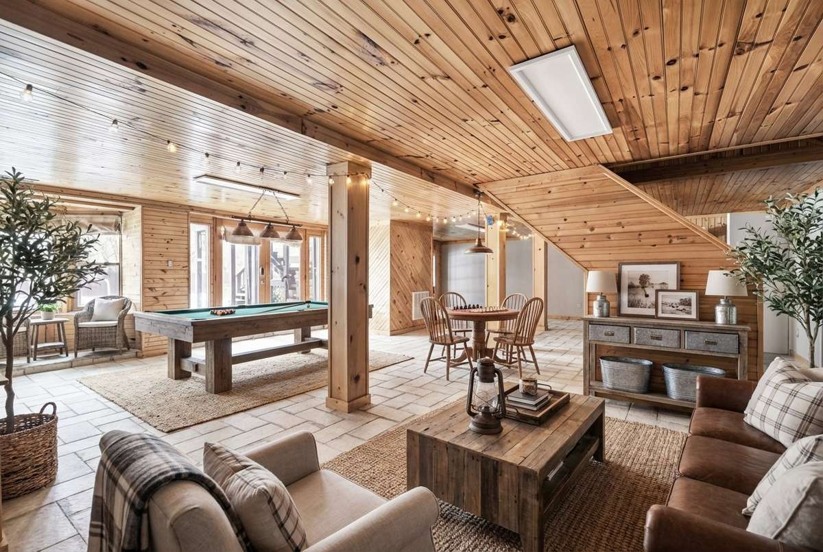 Digitally enhanced image of the finished basement highlights its versatility—relax, work, or play!