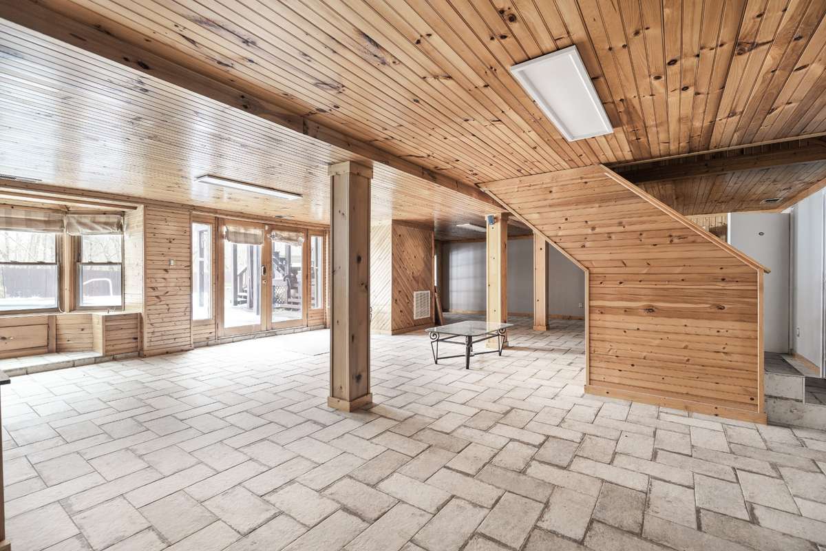Huge basement with updated tile, double exits to the pool & hot tub, a bay window with pool views, plus a shower, sauna, and fireplace—an entertainer’s dream!