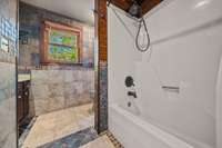 The second-level bathroom features stunning tile walls and flooring, truly a must-see!