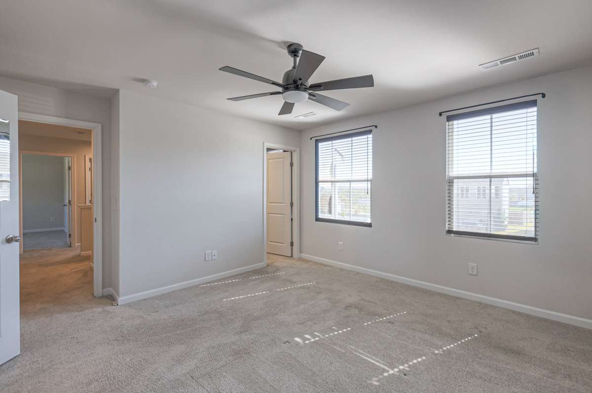 Spacious primary bedroom with abundant natural light.