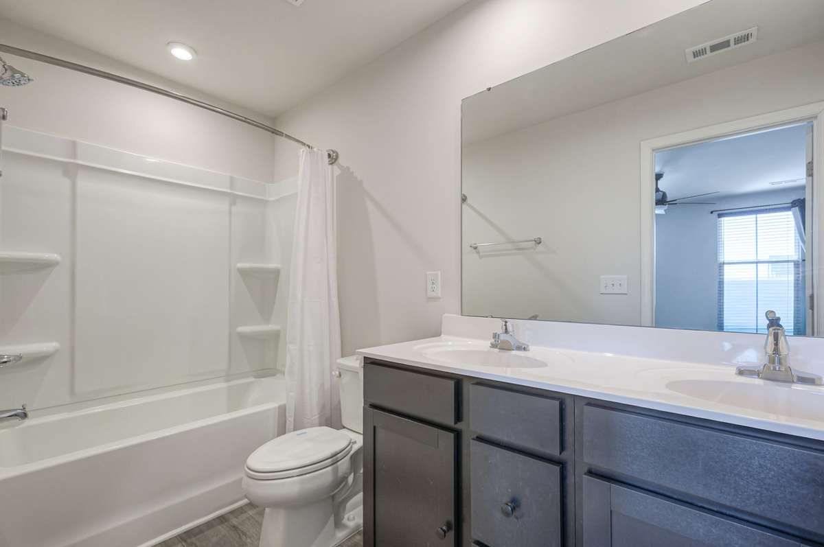 Primary bathroom with dual vanity.