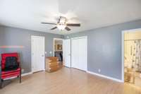 This view of the primary bedroom shows the walk in closet and a 2nd extra large closet.