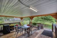 What a fabulous deck. The owner added the roof and has replaced damage decking with new wood. Once the wood has seasoned, it will be ready for stain or paint.