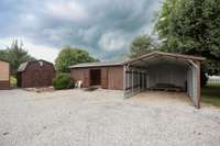 Options! The seller has added to good sized sheds over the years, both with electric. You can make one a workshop and use the other for storage. The carport comes in handy, too!