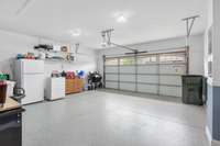 Garage with painted walls and newly finished floor.