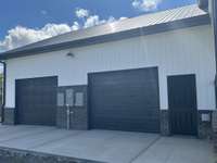 L side pedestrian and 2 car garage doors