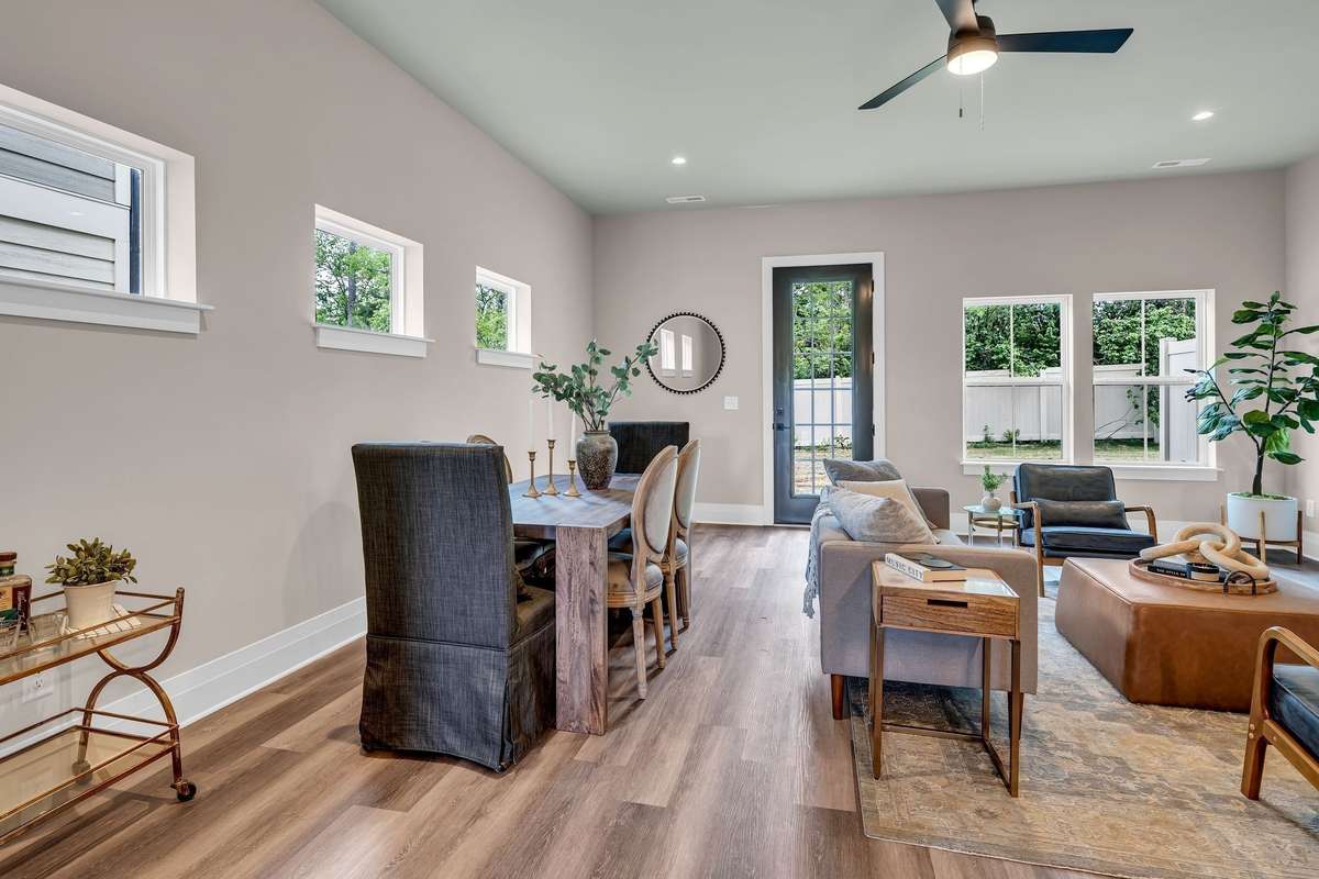 Spacious Living/Dining Area with 10 foot ceilings and 8 foot doors leading into a backyard which can be fenced.