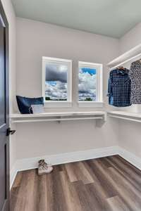 One of Two Closets in the Primary Bedroom with Custom Shelving.