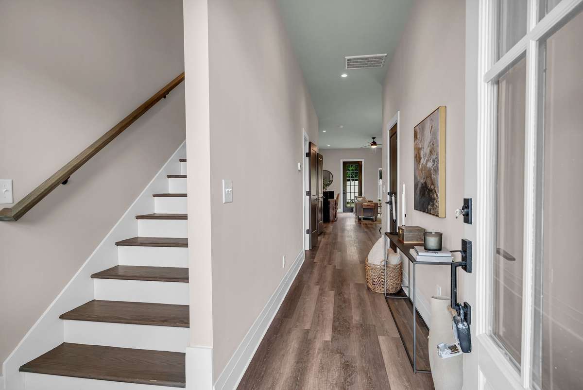 Foyer leading to Powder Room and Kitchen/Living Room Area.