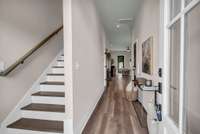 Foyer leading to Powder Room and Kitchen/Living Room Area.
