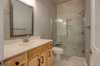 downstair bathroom with full tile walk in shower