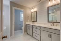 double vanities, private water closet, full tile shower and separate soaking tub complete this master bath