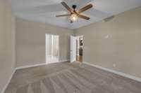 In this photo of the Owner's Suite, we look back toward the attached full bath. This is truly a large room, so bring your big bedroom furniture. It will fit!