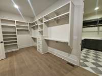 Huge primary closet leading to the layndr room