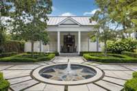 Formal garden with outdoor kitchen and dining area with fireplace