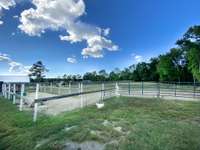 The full view of the home (Hidden behind the trees and the camping retreat.