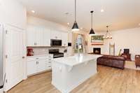 The island offers additional seating, perfect for casual dining or conversations while preparing meals.  Modern touches-such as light fixtures and drawer pulls-add character and style, making the kitchen feel both fresh and timeless.